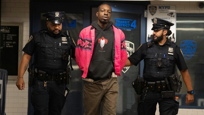 Aaron Walker is accused of punching an off-duty NYPD officer in the back of the head and throwing him onto subway tracks Wednesday.