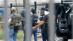 Officers, including Homeland Security Investigations (HIS), gather at the scene of a shooting at a U.S. Immigration and Customs Enforcement office in Dallas on Wednesday. Officers, including Homeland Security Investigations (HIS), gather at the scene of a shooting at a U.S. Immigration and Customs Enforcement office in Dallas on Wednesday.