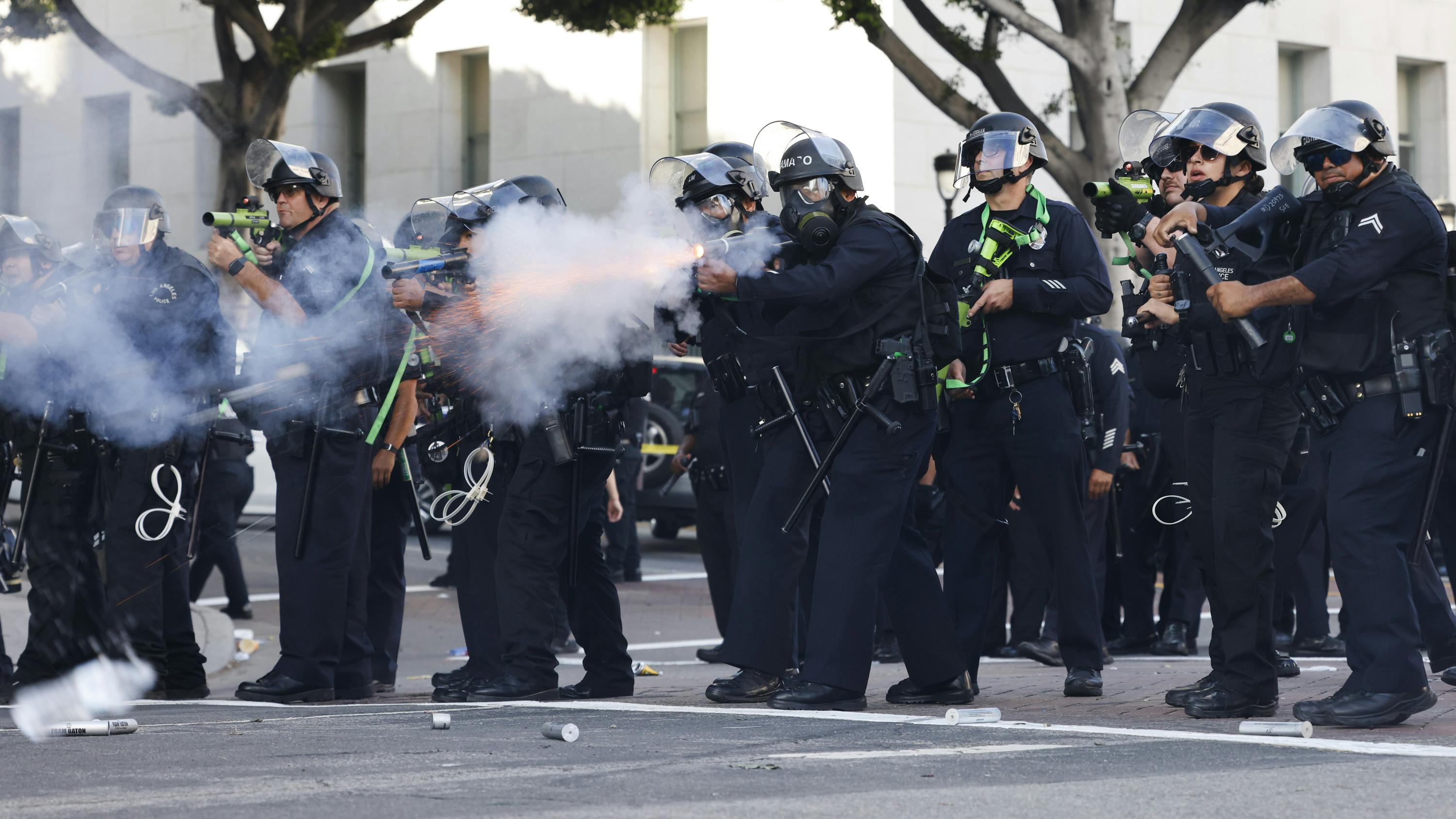 LAPD officers fire less-lethal munitions at anti-ICE protesters on during the 'No Kings Day' rally in June in downtown Los Angeles.