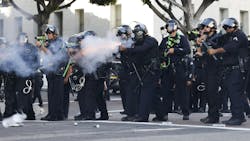 LAPD officers fire less-lethal munitions at anti-ICE protesters on during the 'No Kings Day' rally in June in downtown Los Angeles. LAPD officers fire less-lethal munitions at anti-ICE protesters on during the 'No Kings Day' rally in June in downtown Los Angeles.