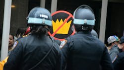 NYPD officers look on during a 'No Kings' protest march in New York City on June 14. NYPD officers look on during a 'No Kings' protest march in New York City on June 14.
