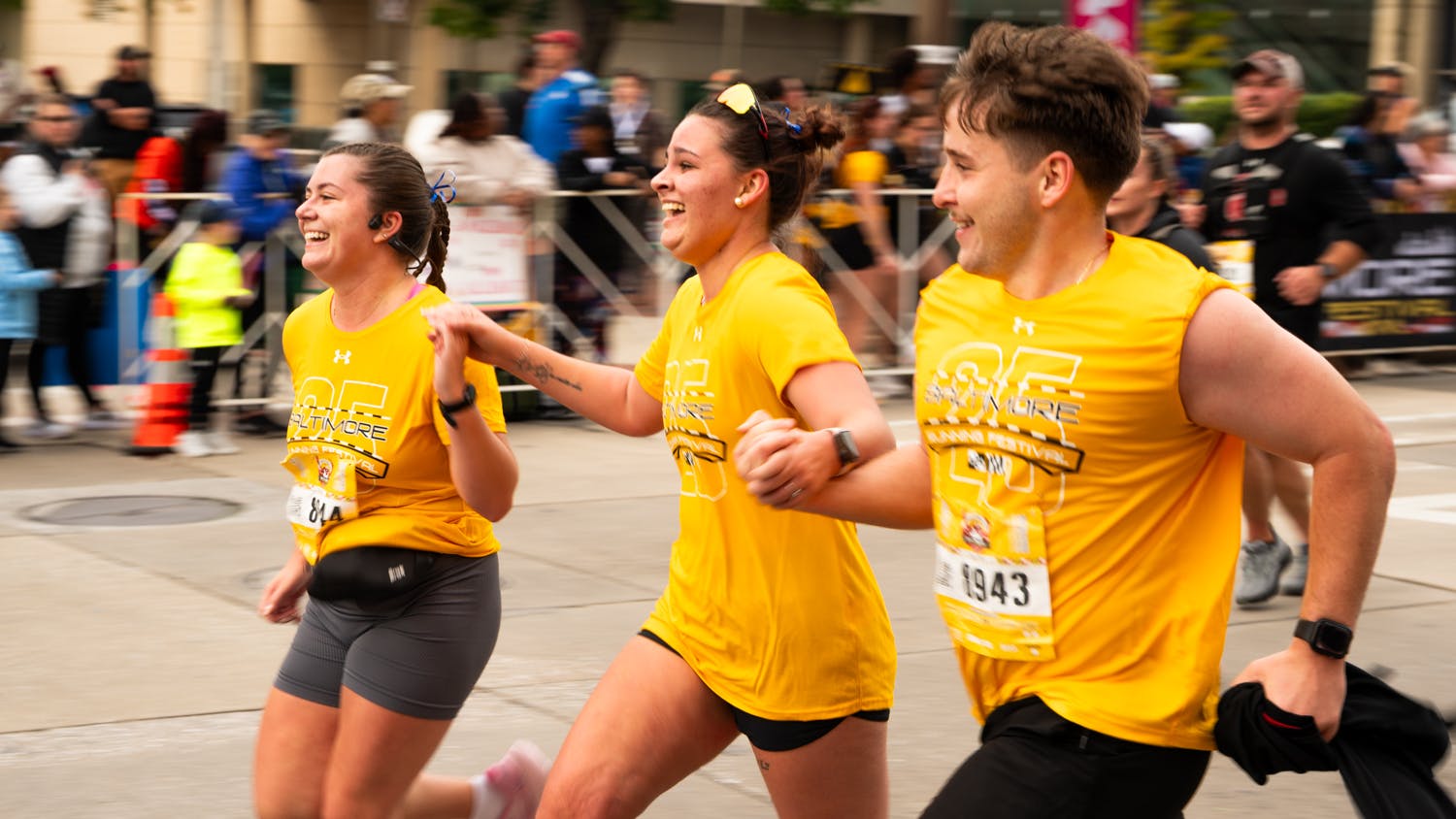 Racers participate in the 25th Baltimore Running Festival on Saturday. A Baltimore police officer suffered a mild skull fracture when he was dragged roughly 20 feet by a driver.