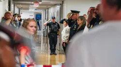 Law enforcement officers salute as an honor walk is performed for El Reno, OK, Police Sgt. Thomas Duran, who died from injuries he suffered in an Oct. 17 hit-and run crash while he was helping a pedestrian.