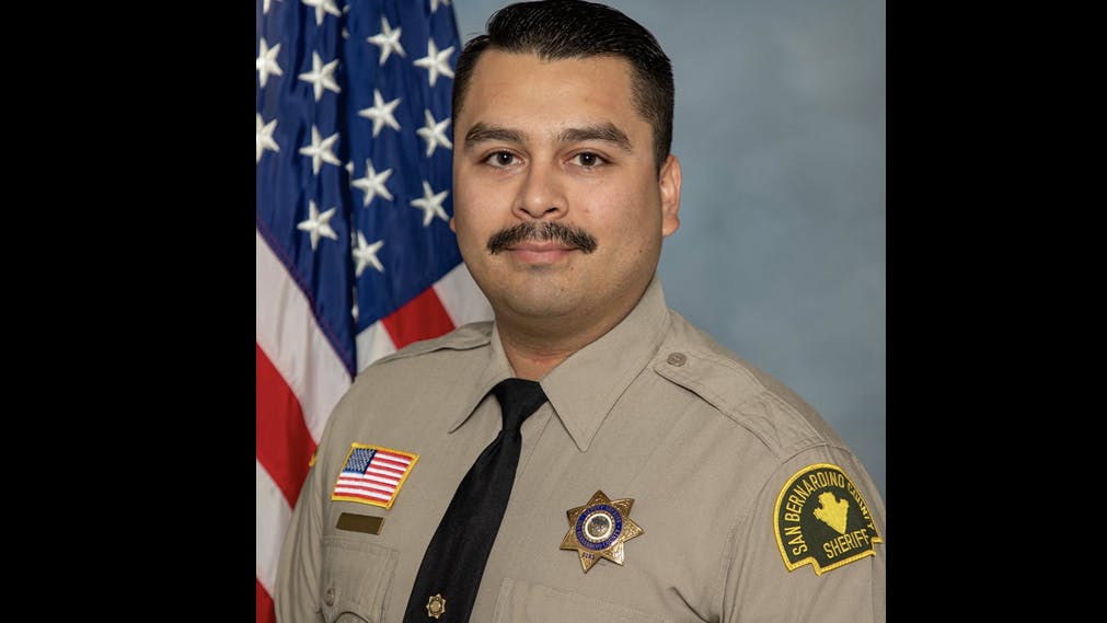 An armed suspect killed San Bernardino County Sheriff's Deputy Andrew Nunez before leading police on a high-speed pursuit that ended when the suspect's motorcycle flipped over a car.