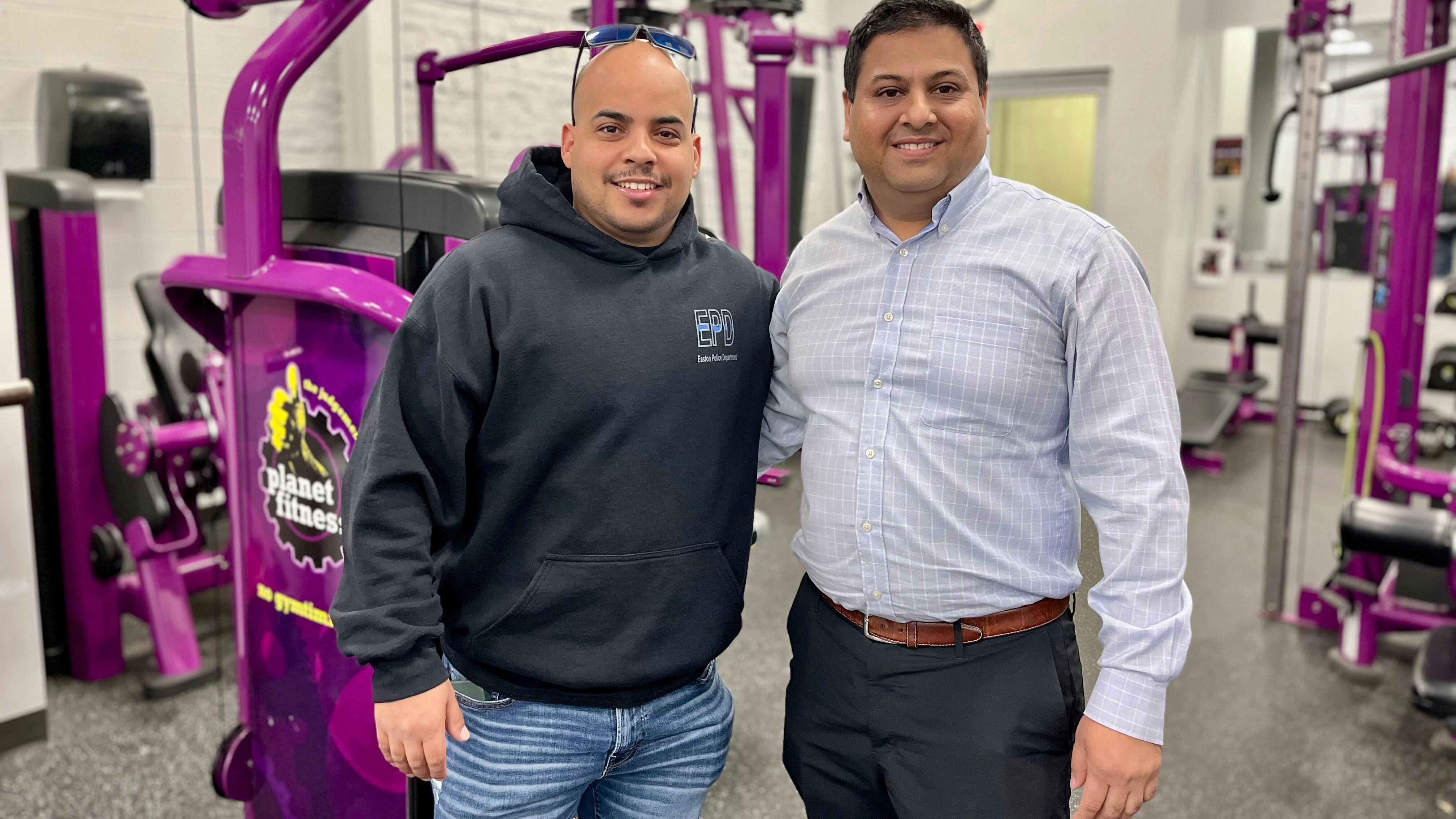 Easton, PA, Police Officer Jonathan Vidal (left) and Planet Fitness Community Coordinator Milan Dalsania facilitated the donation of Planet Fitness equipment to the police department.