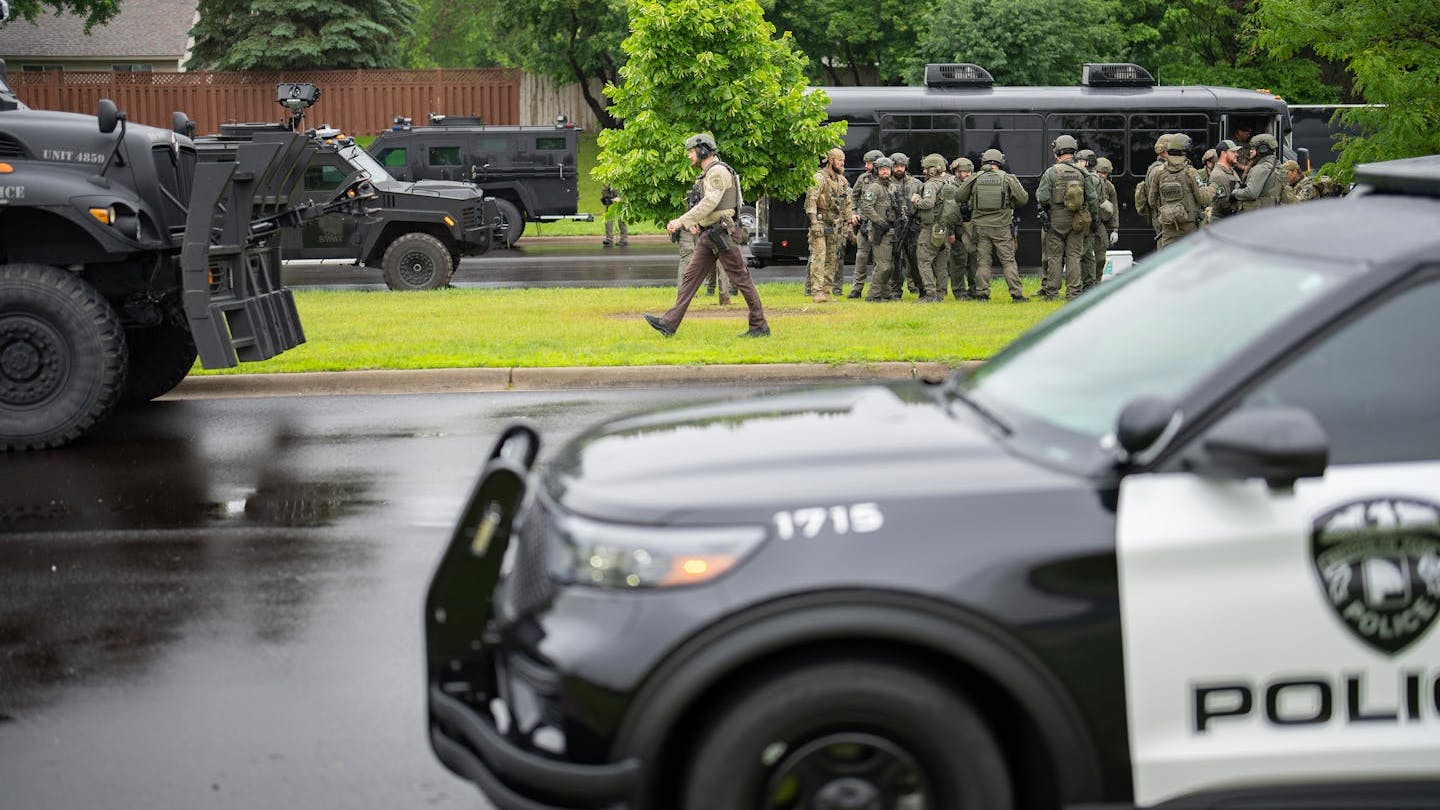 At least 100 law enforcement officers and the FBI gather less than a mile from the home of Minnesota state Rep. Melissa Hortman in Brooklyn Park on June 14.