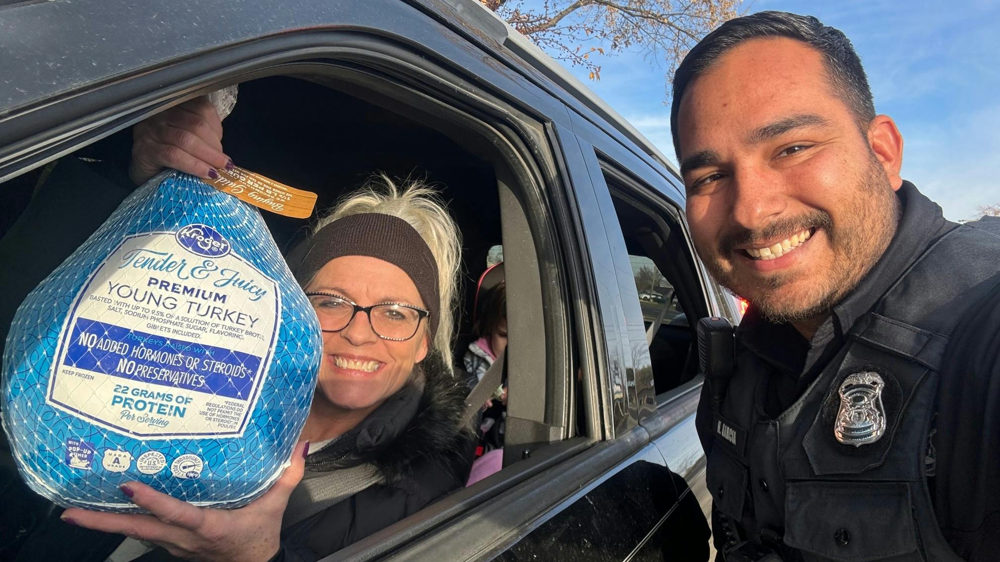 A Southgate, MI, police officer hands out a Thanksgiving turkey instead of a ticket during a 'traffic stop.'