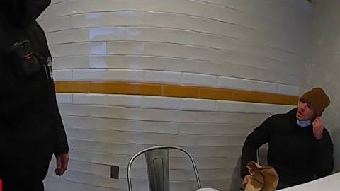 An Altoona, PA, police officer questions Luigi Mangione at a McDonald's last year.