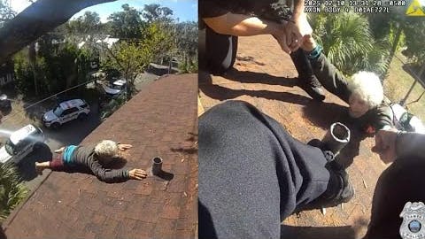 Two Tampa, FL, police officers rescue an elderly man dangling from the roof of a three-story home.