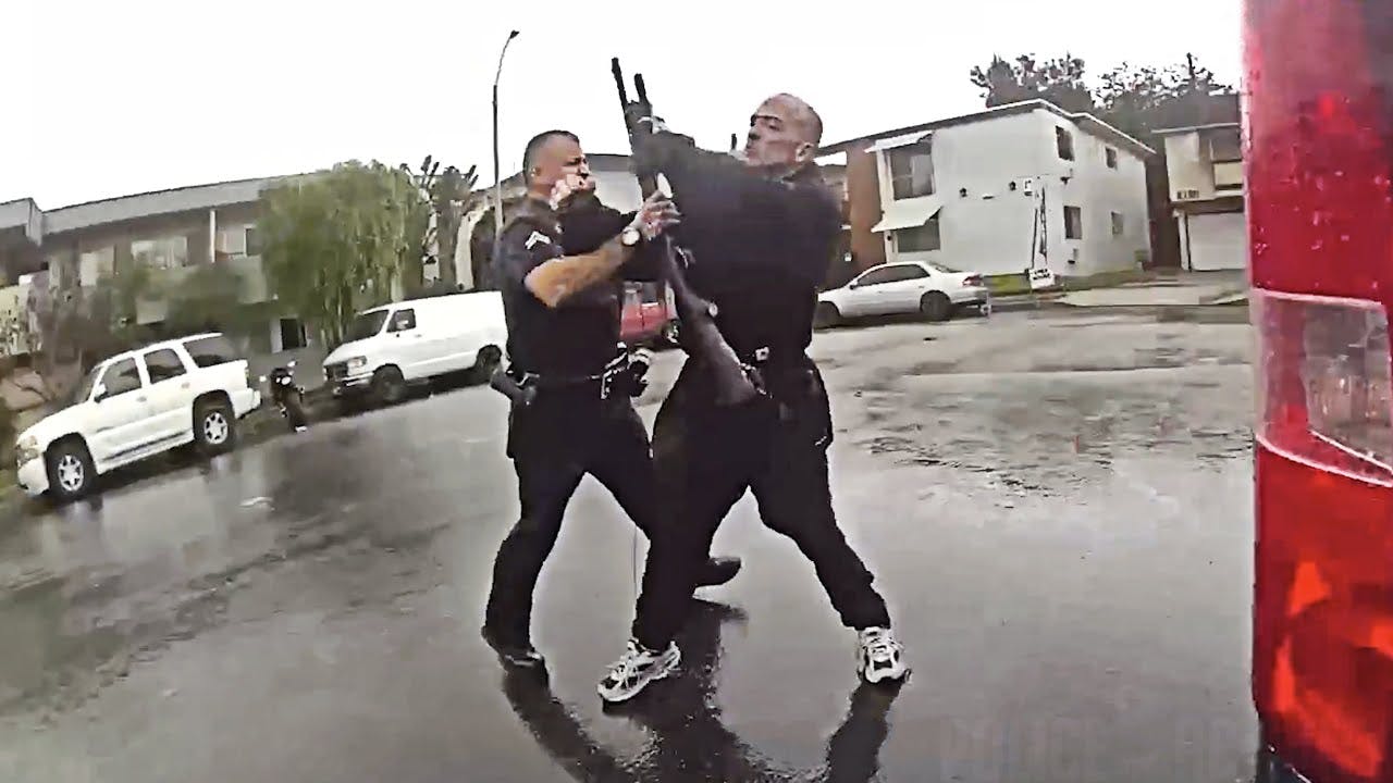 An LAPD officer confronts an armed suspect who opened fire at police.