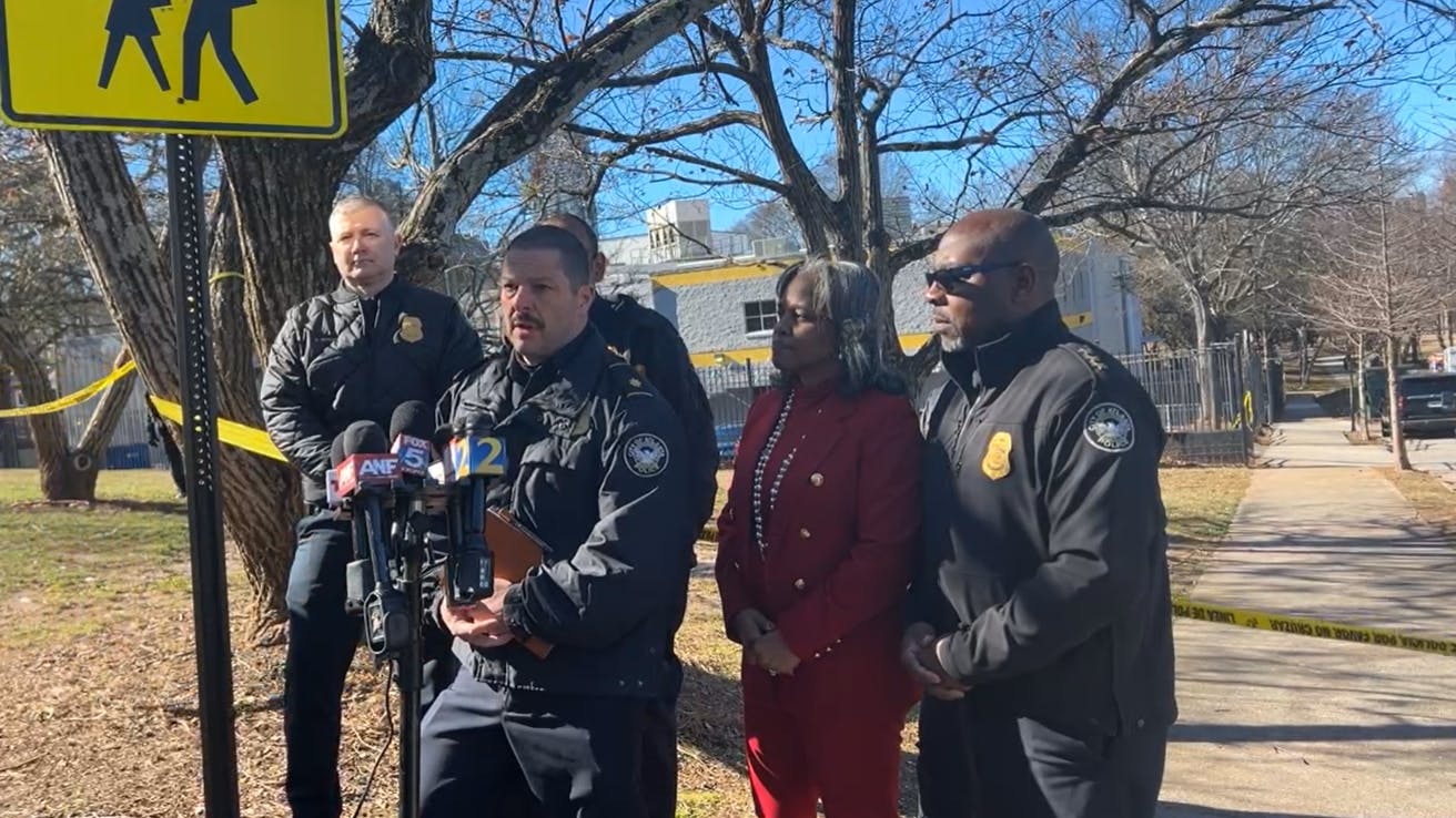 Atlanta Police Department officials speak to reporters after an officer working an off-duty security assignment opened fire during a shooting outside a city warming center.