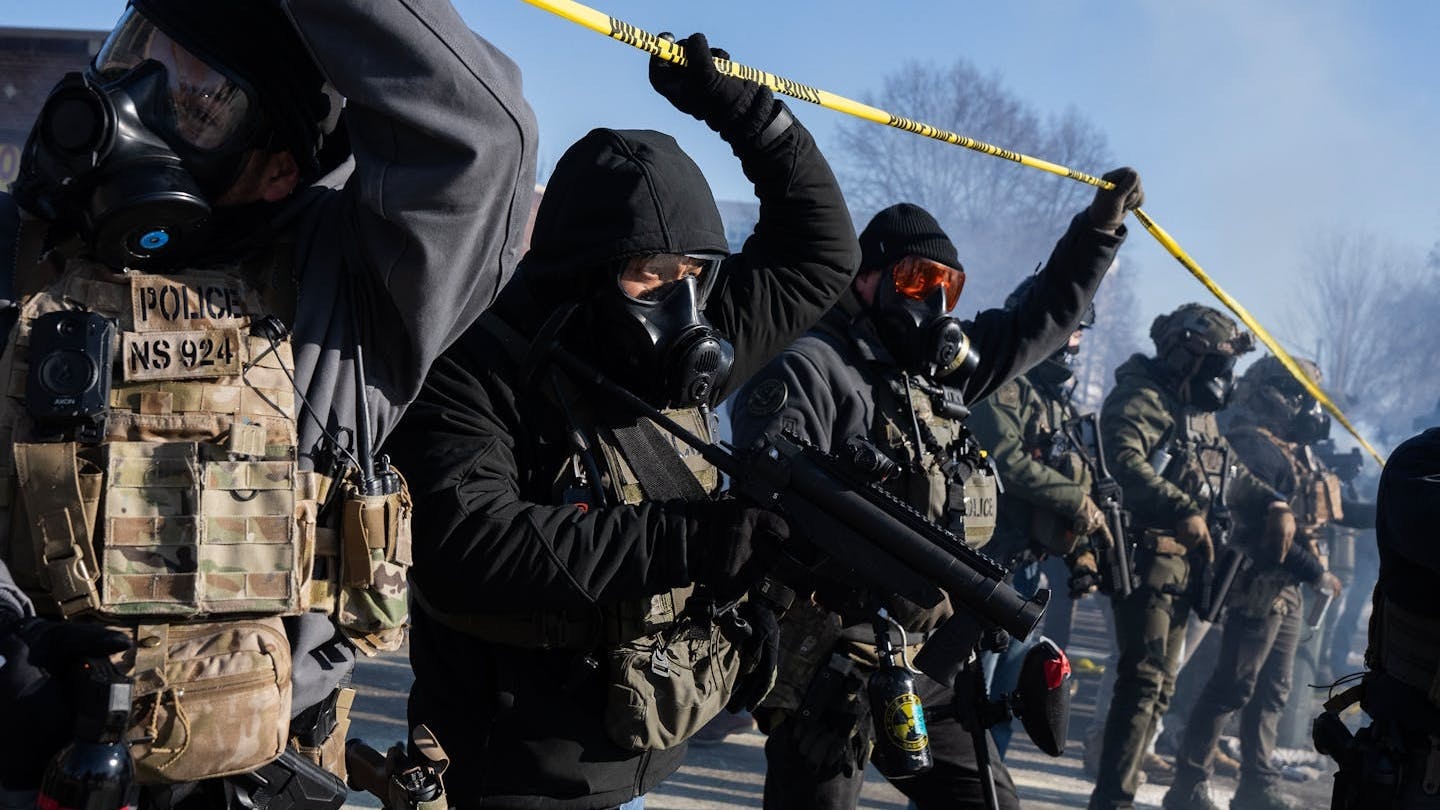 Federal agents move toward protesters at the scene where a federal agent shot and killed Alex Pretti in south Minneapolis on Saturday, Jan. 24.