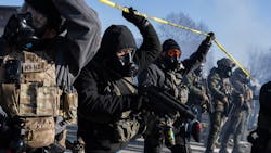 Federal agents move toward protesters at the scene where a federal agent shot and killed Alex Pretti in south Minneapolis on Saturday, Jan. 24. Federal agents move toward protesters at the scene where a federal agent shot and killed Alex Pretti in south Minneapolis on Saturday, Jan. 24.