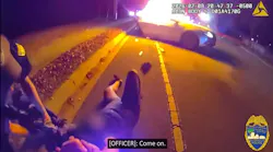 A Jacksonville, FL, sheriff's officer pulls a driver from a fiery crash.
