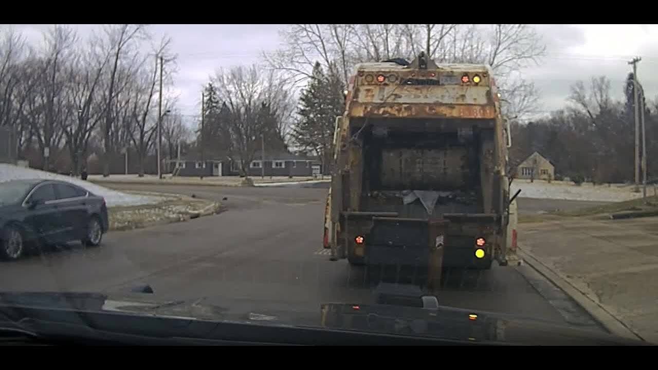 A suspect fleeing Huber Heights police chose an unfortunate hiding spot when a sanitation worker dumped him out of a trash can and into a garbage truck in front of an officer.