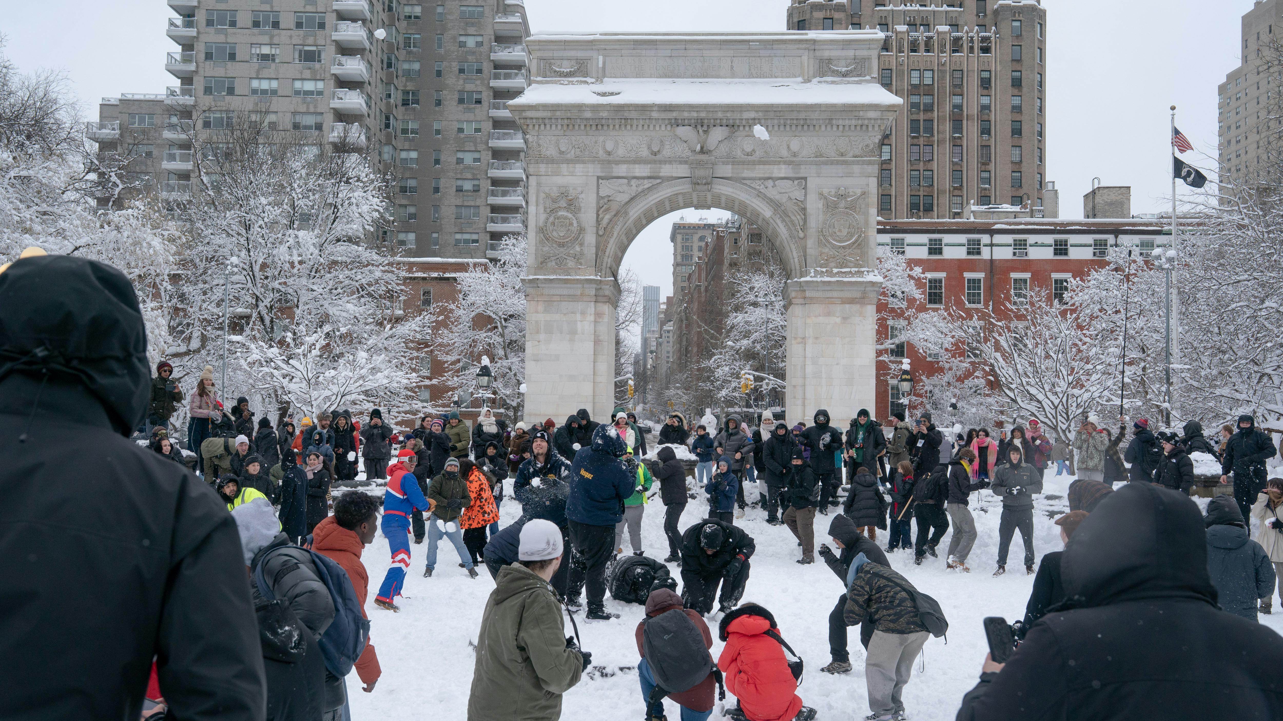 Crowd bombards NYPD officers with snowballs at Washington Square Park.