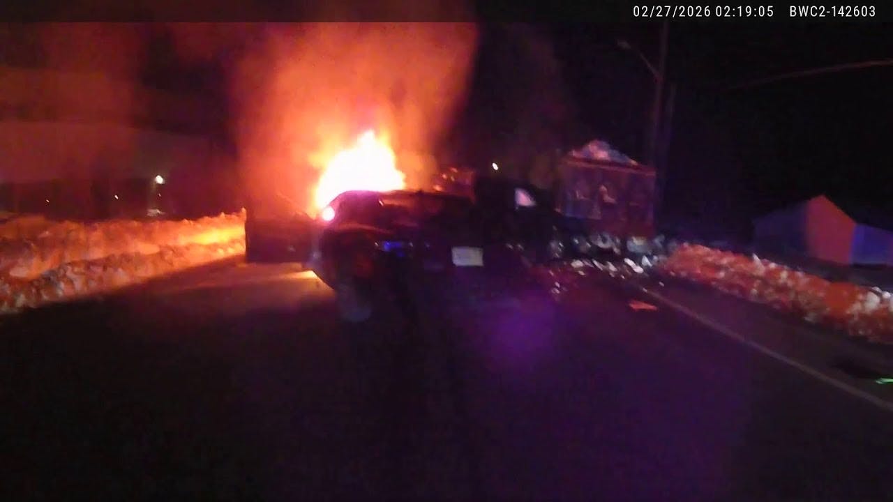 Easton, MA, police officer helps save trapped driver in burning pickup truck.