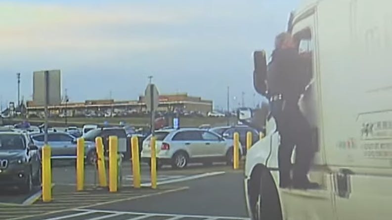 Springfield Township, OH, police officer clings to semi.