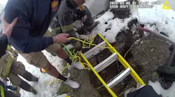 Suffolk County, NY, police officers pull small dog out of collapsed cesspool.