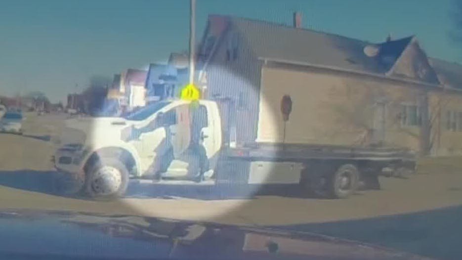 Milwaukee police officer hangs from fleeing truck's window