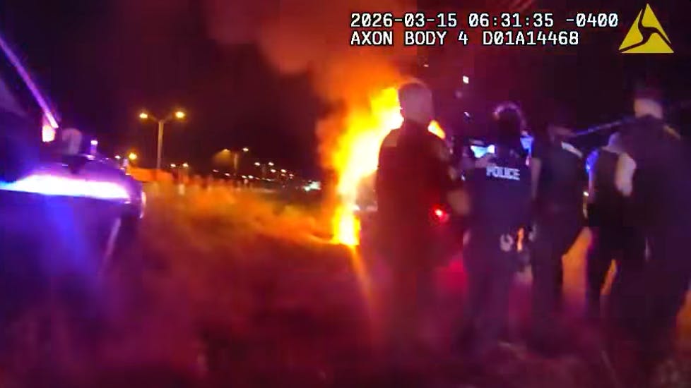 Police use shields to reach a road rage suspect in a Daytona Beach, FL, cruiser he set on fire.