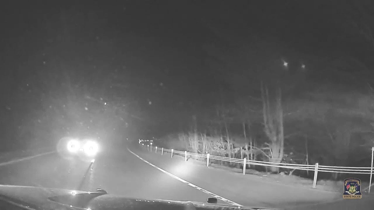 Connecticut State Police trooper tries to block path of wrong-way driver.