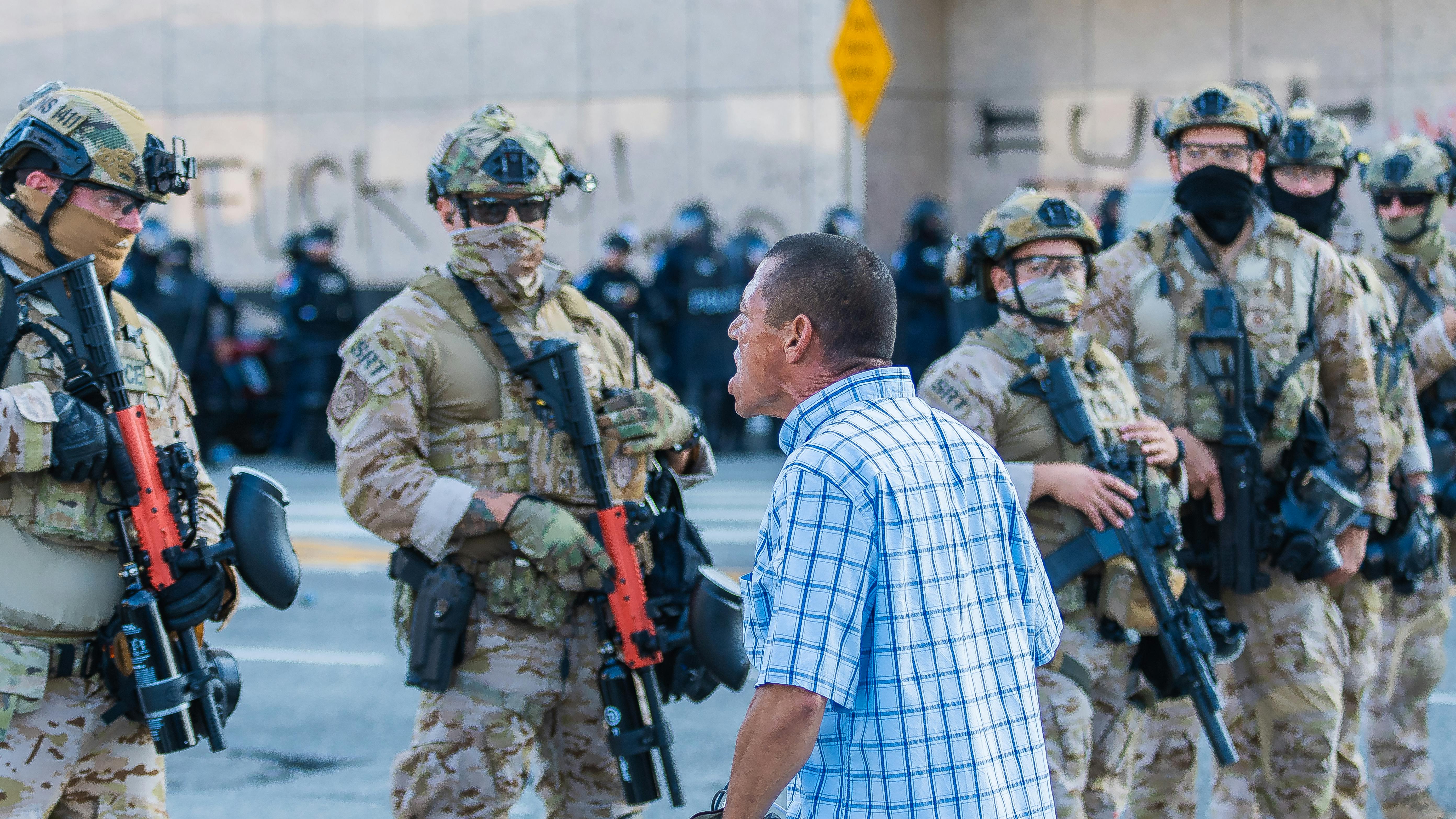 A man is seen shouting at a Border Patrol agent during anti-ICE protest in downtown Los Angeles.
