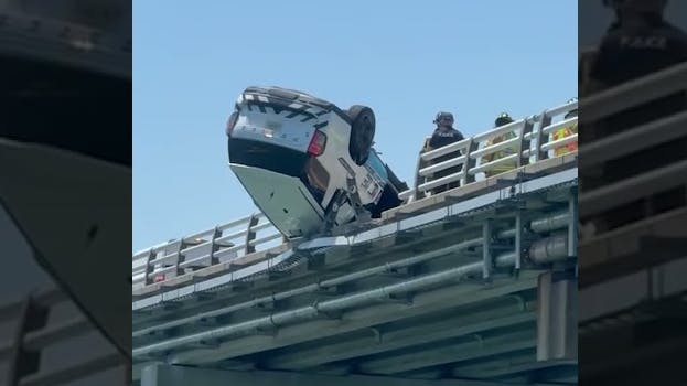 Chesapeake Bay Bridge-Tunnel police SUV hangs off guardrail