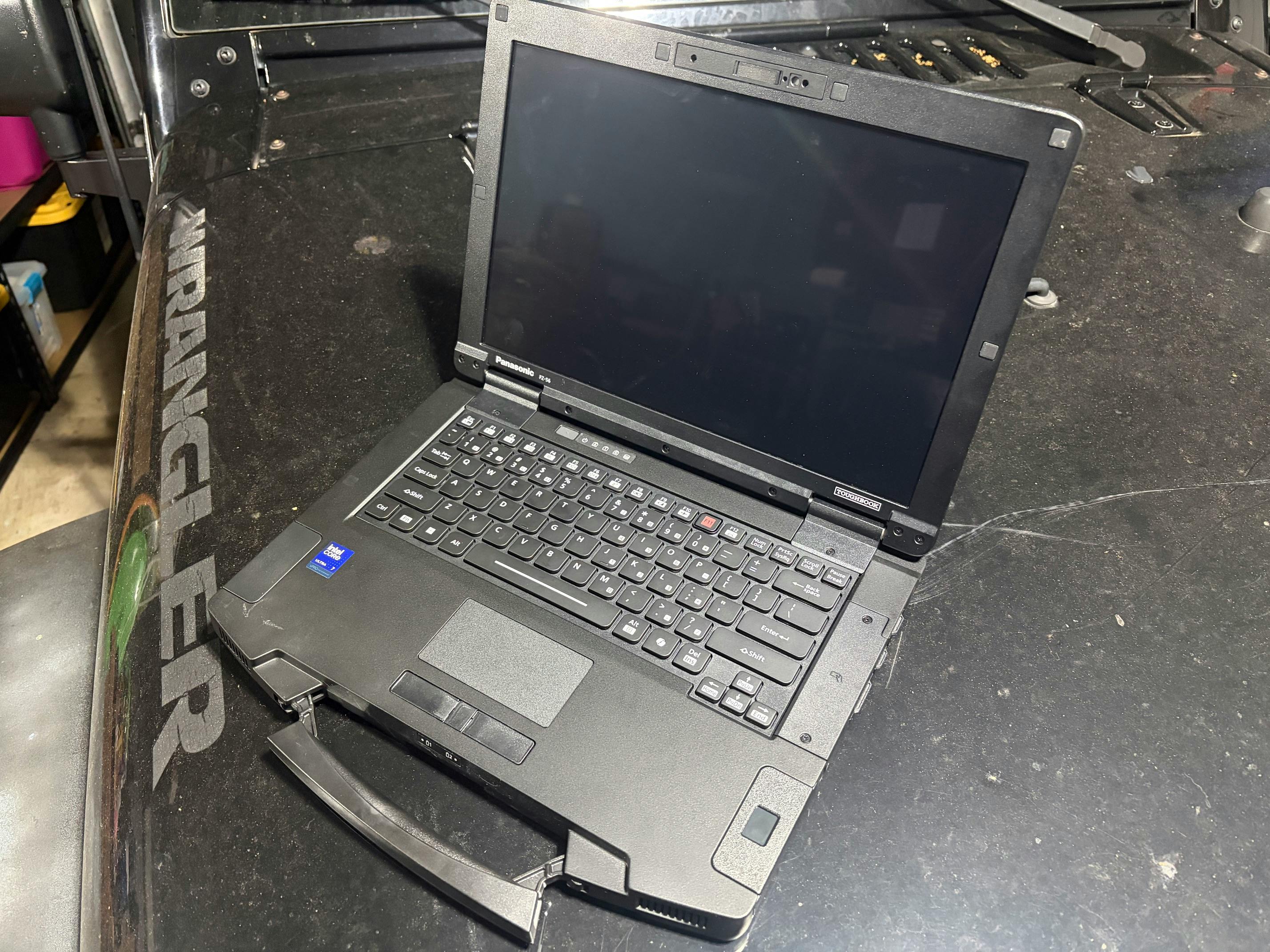 The TOUGHBOOK 56 test unit often found itself on the dirty hood of a Jeep... shown in the garage but tested on dirt roads.