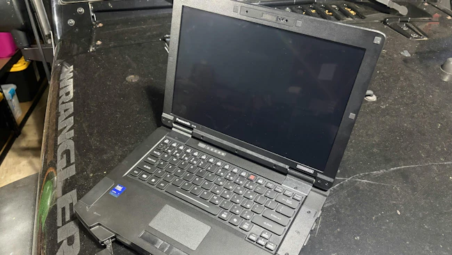 The TOUGHBOOK 56 test unit often found itself on the dirty hood of a Jeep... shown in the garage but tested on dirt roads.
