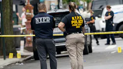 NYPD officers investigate the shooting of a fellow officer struck in the back