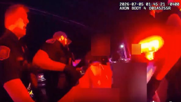Grand Rapids police carry shooting victim to ambulance