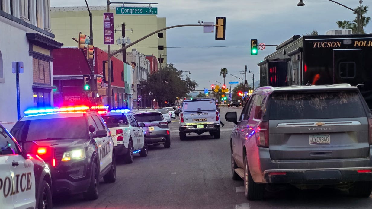 A Tucson police officer shot a suspected gunman early Sunday after authorities said the suspect opened fire in a crowded downtown area, wounding nine people before officers intervened.