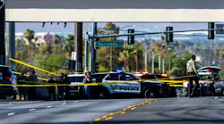 Las Vegas police officers gather along Mountain Vista Street after a fellow officer was fatally shot Tuesday. A 30-year-old officer died following a gun battle with an armed suspect nearby, Sheriff Kevin McMahill said.