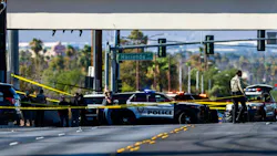 Las Vegas police officers gather along Mountain Vista Street after a fellow officer was fatally shot Tuesday. A 30-year-old officer died following a gun battle with an armed suspect nearby, Sheriff Kevin McMahill said.