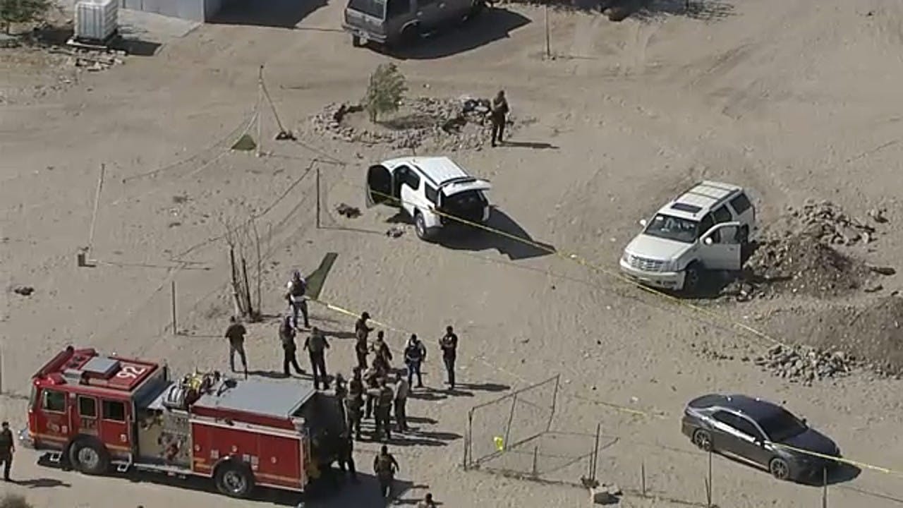Investigators at the scene of a shooting involving a San Bernardino County sheriff's detective