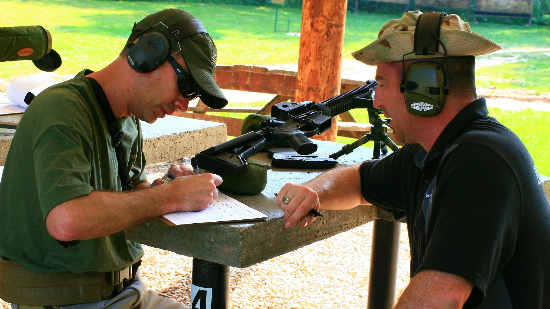 Instructor and a shooter talk during a firearms course at a Maryland gun range
