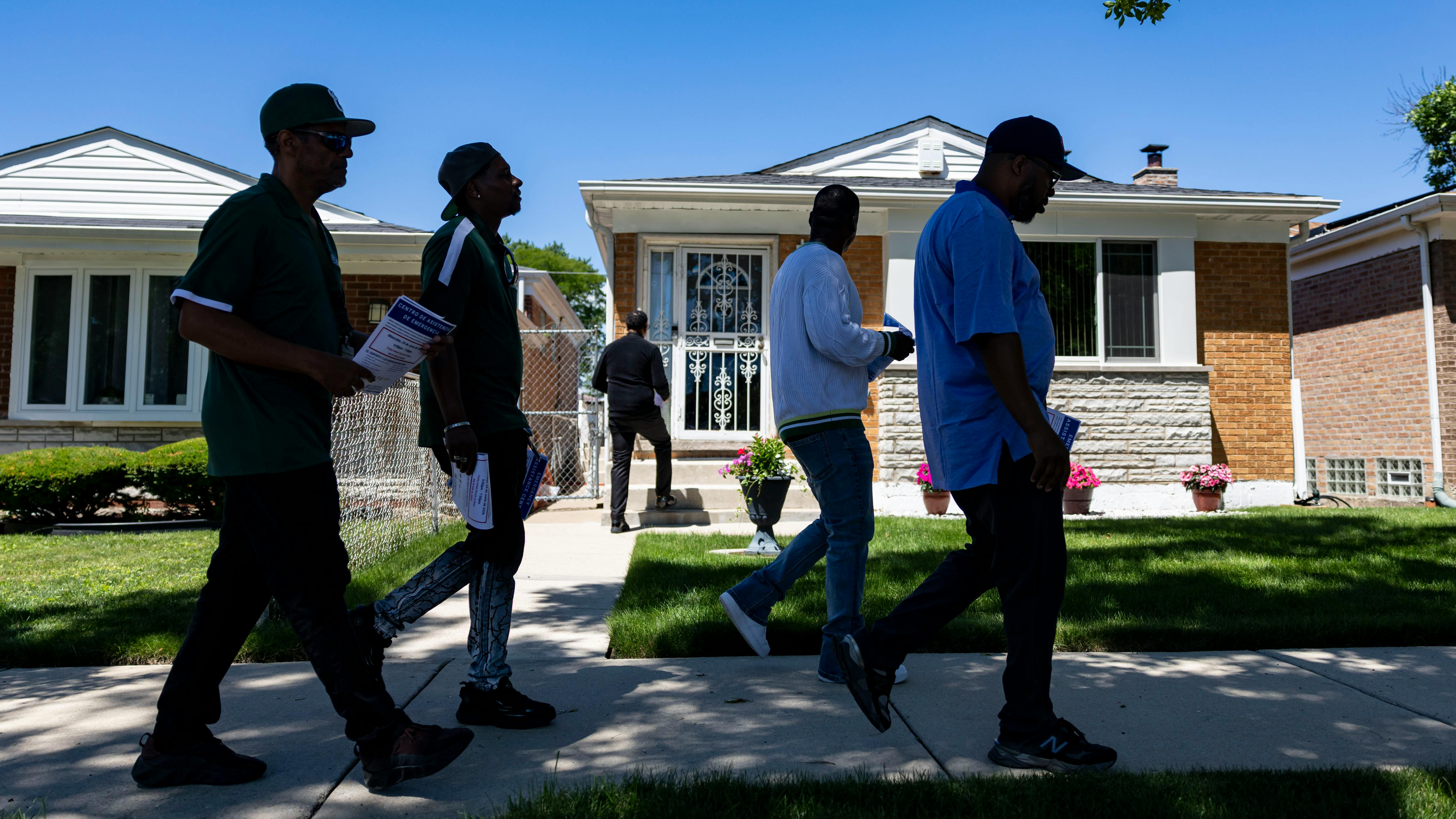 Community violence interrupters and representatives from the Chicago Police Department&rsquo;s Office of Victim Services canvass a neighborhood