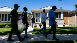 Community violence interrupters and representatives from the Chicago Police Department’s Office of Victim Services canvass a neighborhood