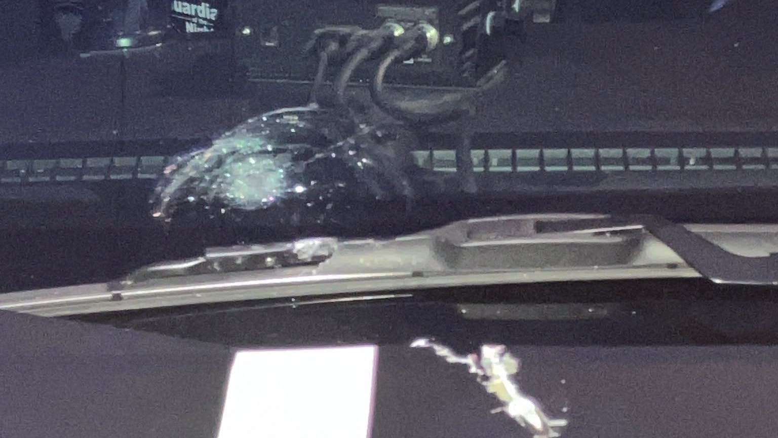 A Ramsey County deputy's windshield shows damage after a suspect's bullet struck it