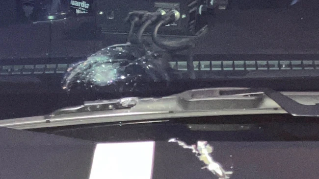 A Ramsey County deputy's windshield shows damage after a suspect's bullet struck it