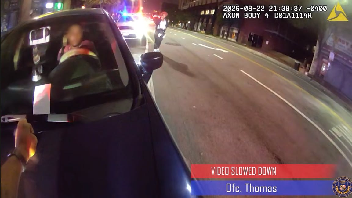 Baltimore police officer lands on a car hood after he was struck by a fleeing suspect