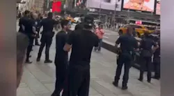 NYPD officers confront a woman armed with knives who was accused of stabbing two strangers