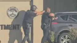 Port Orange police officers confront a woman accused of opening fire inside a station lobby