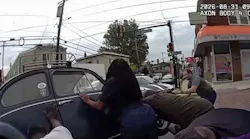 Body camera footage shows a Prospect Park police officer and bystanders saving a woman on an e-bike trappened underneath a Volkswagen