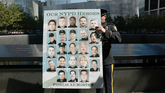 NYPD officer displays poster honoring lives of NYPD officers lost during 9/11