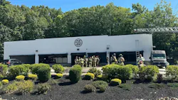 Firefighters work at the scene of three-alarm fire at the Sig Sauer facility in Epping