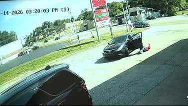 A suspect drags a Florissant police detective during an arrest attempt at a gas station