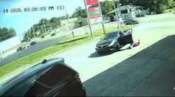A suspect drags a Florissant police detective during an arrest attempt at a gas station