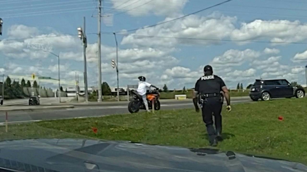 A York Regional Police officer sneaks up on a motorcyclist accused of fleeing a crash scene
